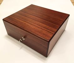 a wooden box sitting on top of a white table