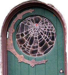 a green door with a cracked glass window