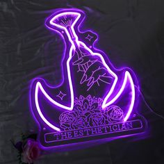 a purple neon sign that says the best christian on it with an image of a boat and flowers