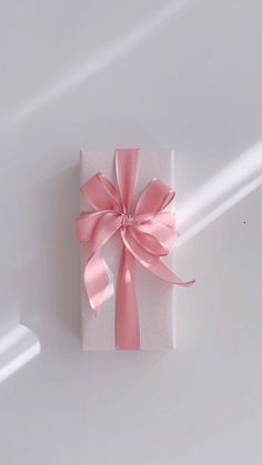 a white box with a pink bow on it