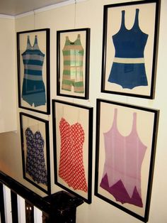 there are many pictures hanging on the wall in this room, and one is displaying different dresses