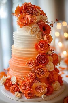 an orange and white wedding cake with flowers on it