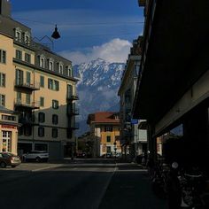 a city street with mountains in the background