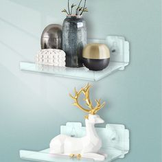 there are two shelves that have decorative items on them and one shelf has a deer figurine