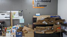 cardboard boxes and other items are piled on the floor