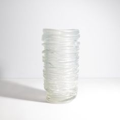 a glass vase sitting on top of a white table