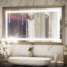 a bathroom sink sitting under a large mirror next to a vase with flowers on it