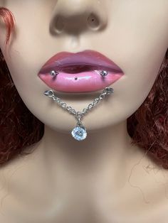 a mannequin wearing a necklace with a diamond on it's lip and nose