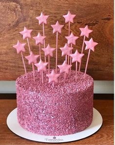 there is a pink cake with stars on it