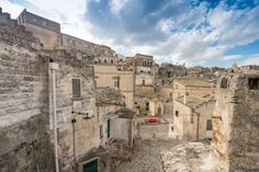 an aerial view of some buildings in the old part of town with blue sky and clouds