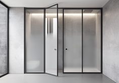 an empty room with glass doors and white walls