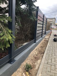 the side of a building that is being constructed with metal and glass panels on it