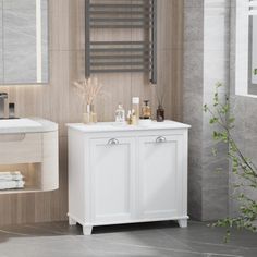 a bathroom with a sink, mirror and towel rack in it's corner next to the bathtub