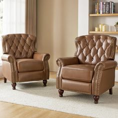 two brown leather chairs sitting next to each other on a white carpeted room floor