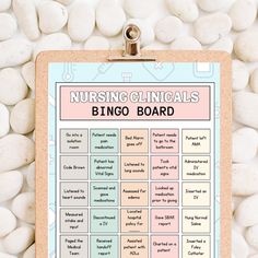 a clipboard with the words, nursing clinics and bingo board on it surrounded by white rocks