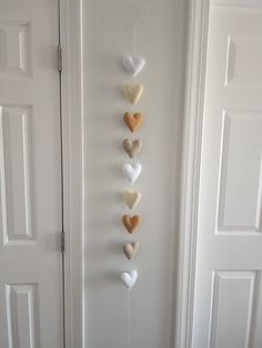 a group of hearts hanging from the side of a door