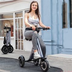 a woman riding an electric scooter on the street