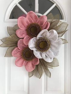 a white door with two pink and white flowers on it