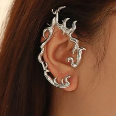 a woman's ear with an intricate design on it