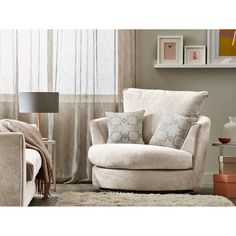 a living room scene with focus on the chair and pillows in front of the window