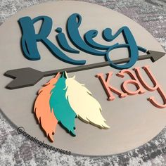 a sign that says riley kay with an arrow