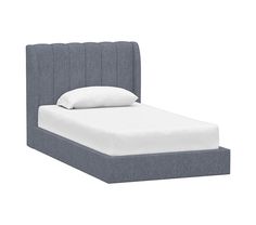 an upholstered bed with white pillows and a blue headboard is shown in front of a white background