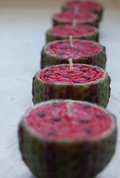 four candles with red and green designs on them