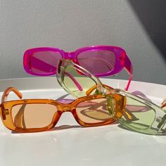 three pairs of glasses sitting on top of a white plate with one pair in the middle