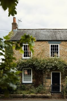 an old brick house with ivy growing on it