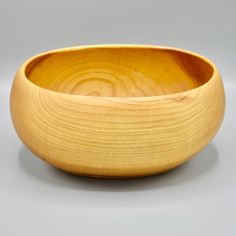 a wooden bowl sitting on top of a table