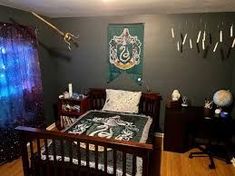 a bed room with a neatly made bed and a harry potter flag on the wall