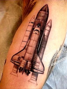 a black and white photo of a space shuttle tattoo