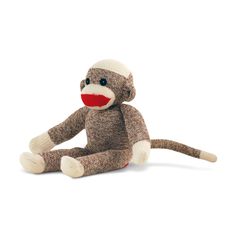 a stuffed monkey sitting on the ground