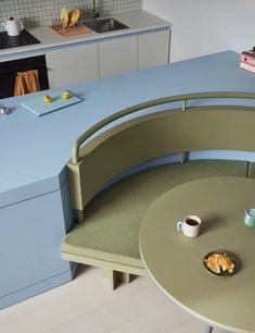 a blue counter top in a kitchen next to a table with a plate of food on it