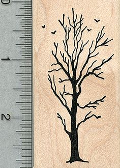 a rubber stamp with a tree and birds on it