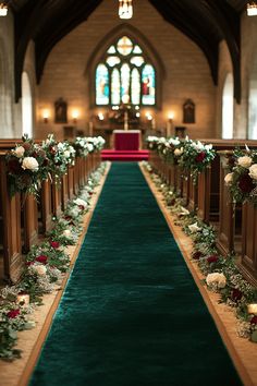 the aisle is decorated with flowers and greenery