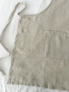 an apron is laying on top of a white sheet