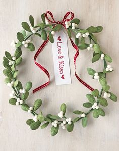 a wreath made out of leaves and berries with a tag attached to it that says, you're the best