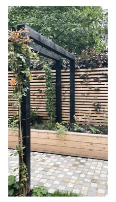 an outdoor garden with wooden slats and plants