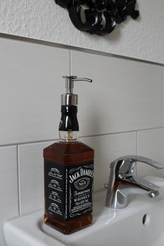 a soap dispenser sitting on top of a sink next to a faucet