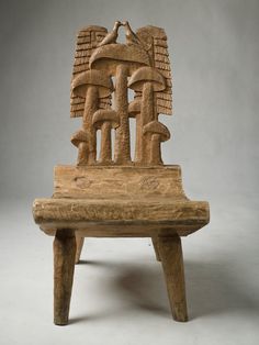 a wooden chair with carvings on the back