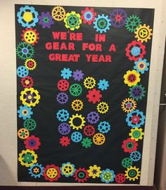 a classroom door decorated with gears and the words we're in gear for a great year