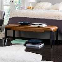 a bed sitting next to a wooden table in a bedroom