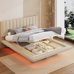 a bed that is sitting in the middle of a room with an open drawer underneath it