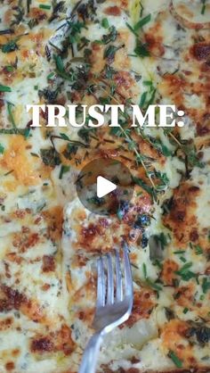 a close up of a pizza on a pan with a fork