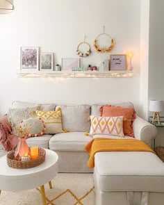 a living room filled with lots of furniture and decor on top of a white wall