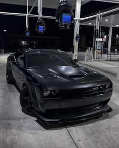 a black sports car parked in a garage