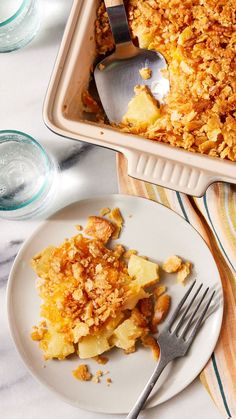 a white plate topped with food next to a casserole dish