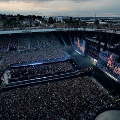 an aerial view of a concert venue with people on the stage and in the stands