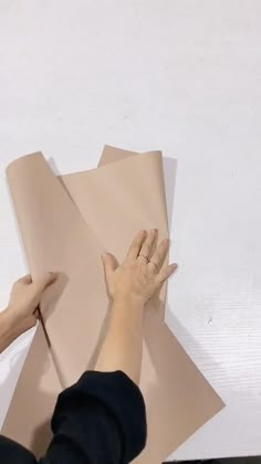 two hands on top of a piece of paper